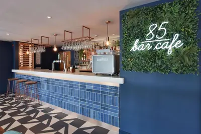 a bar in a restaurant with a blue wall at Travelodge Blackpool South Shore in Blackpool