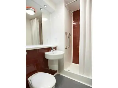 a bathroom with a toilet and a sink and a shower at Travelodge Lytham St Annes in Saint Annes on the Sea