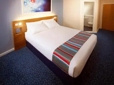 a bedroom with a large bed in a hotel room at Travelodge Lytham St Annes in Saint Annes on the Sea