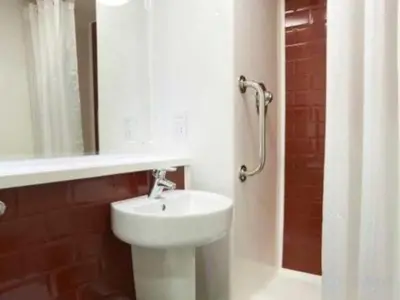 a bathroom with a white sink and a mirror at Travelodge Lytham St Annes in Saint Annes on the Sea