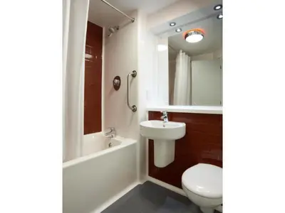 a bathroom with a sink and a toilet and a bath tub at Travelodge Lytham St Annes in Saint Annes on the Sea