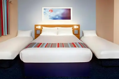 two twin beds in a hotel room at Travelodge Burton M6 Northbound in Holme