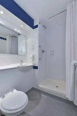 a bathroom with a toilet and a sink and a shower at Travelodge Barrow In Furness in Barrow in Furness