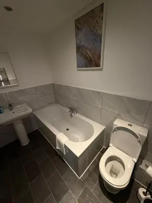 a bathroom with a tub and a toilet and a sink at City Centre 4 Bedroom Apartment with Terrace Sleeps 10 by StaySavvy Accommodation in Liverpool