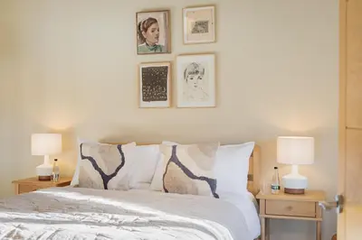 a bedroom with a bed with three pictures on the wall at The Royal Oak Barn Cartmel - Sleeps 4 in Cartmel