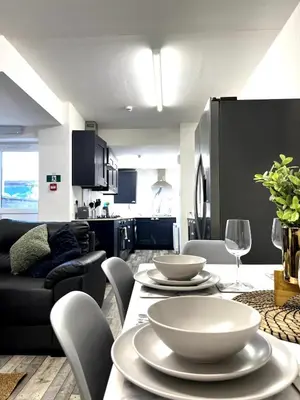 a living room with a table with bowls on it at Contractors House - 10 Seperate Beds - FREE Parking in Liverpool