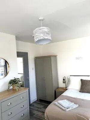 a bedroom with a bed and a dresser at Contractors House - 10 Seperate Beds - FREE Parking in Liverpool