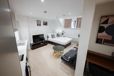 a living room with a couch and a tv at Luxury Studio Apartment in Liverpool City Centre in Liverpool