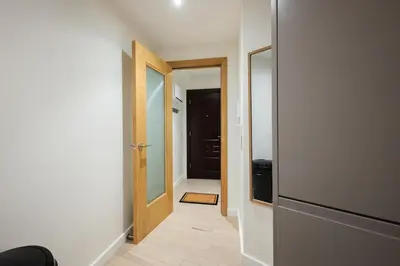 an empty hallway with a door and a mirror at Luxury Studio Apartment in Liverpool City Centre in Liverpool