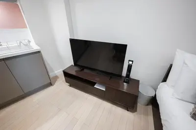 a living room with a flat screen tv on a table at Luxury Studio Apartment in Liverpool City Centre in Liverpool