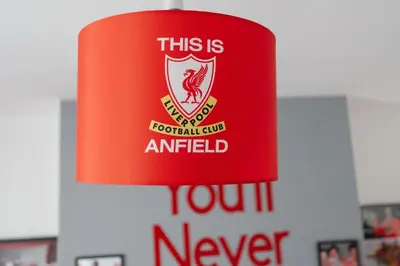 a red sign that reads this is football club amazed you never at The Red One-Sleeps 16, near Anfield & City Centre in Liverpool