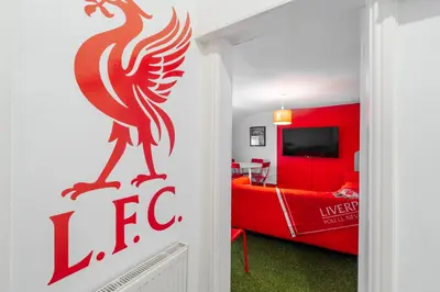 a red bedroom with a red bed and a red wall at The Red One-Sleeps 16, near Anfield & City Centre in Liverpool