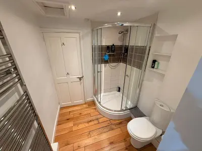 a small bathroom with a shower and a toilet at Sanders Grove in Morecambe