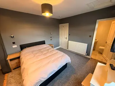 a bedroom with a large bed in a room at Sanders Grove in Morecambe