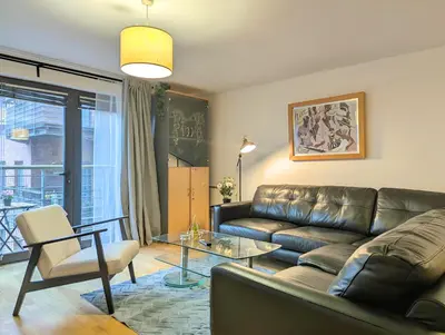 a living room with a couch and a glass table at Spacious 2-Bedroom Apt in Heart of City Centre in Liverpool