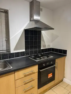 a kitchen with a stove and a sink at The Fabulous Gem in Wallasey in Wallasey