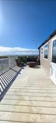 a deck with chairs and a view of the ocean at Sea view 1 in Heysham