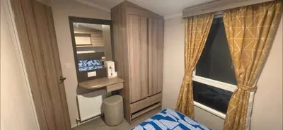 a small room with a window and a bed in a room at Sea view 1 in Heysham