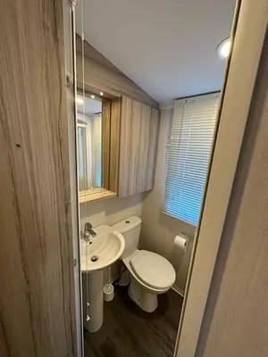 a bathroom with a white toilet and a sink at Sea view 1 in Heysham