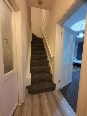 a hallway with a staircase in a house at Warm & Welcoming Balfour Getaway in Wallasey
