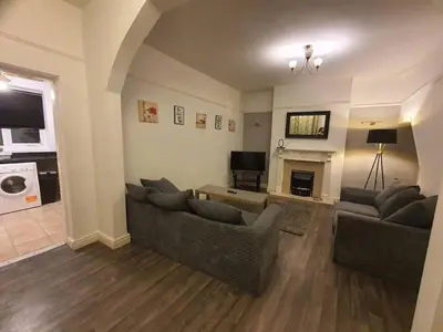 a living room with two couches and a fireplace at Warm & Welcoming Balfour Getaway in Wallasey