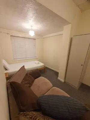 a living room with a couch and a table at Warm & Welcoming Balfour Getaway in Wallasey