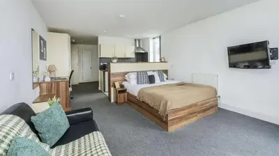 a large bedroom with a bed and a couch at For Students Only Windsor Court in Liverpool in Liverpool