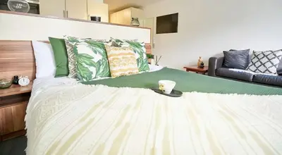 a bedroom with a large bed with a cup of coffee on it at For Students Only Windsor Court in Liverpool in Liverpool