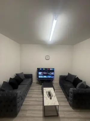 a living room with two couches and a tv at Stylish Dream Home with 4 En-Suite Bedrooms in Liverpool