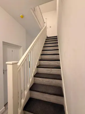 a staircase in a home with white railings at Stylish Dream Home with 4 En-Suite Bedrooms in Liverpool