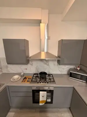 a kitchen with a stove and a microwave at Stylish Dream Home with 4 En-Suite Bedrooms in Liverpool