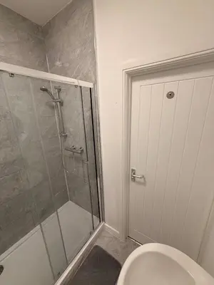 a bathroom with a shower and a toilet at Stylish Dream Home with 4 En-Suite Bedrooms in Liverpool
