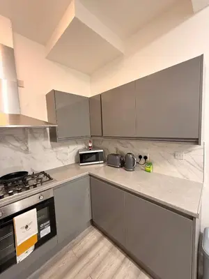 a kitchen with stainless steel cabinets and a stove at Stylish Dream Home with 4 En-Suite Bedrooms in Liverpool