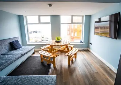 a living room with a couch and a table at Soho Duplex Promenade Seaview Apartment in Blackpool