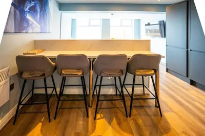 a kitchen with a table and four chairs at Soho Duplex Promenade Seaview Apartment in Blackpool