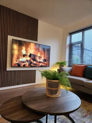a living room with a fire on the wall at Kashkana Haven - Blackburn in Cherry Tree