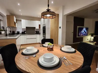 a dining room table with chairs and a kitchen at Kashkana Haven - Blackburn in Cherry Tree