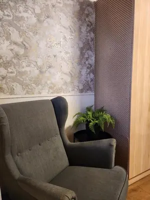 a living room with a chair and a plant at Kashkana Haven - Blackburn in Cherry Tree