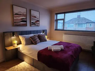 a bedroom with a large bed with a large window at Kashkana Haven - Blackburn in Cherry Tree