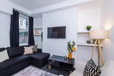 a living room with a couch and a table at Modern 3BR House in Liverpool - Garden in Liverpool