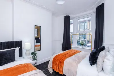 a white bedroom with two beds and a window at Modern 3BR House in Liverpool - Garden in Liverpool