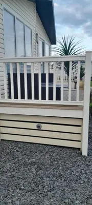 a white fence in front of a house at Jasper Lodge in Morecambe