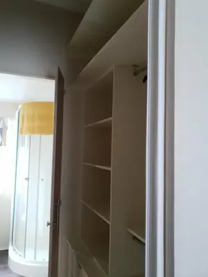 a closet with empty shelves in a room at Jasper Lodge in Morecambe