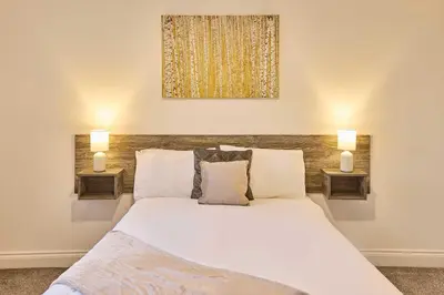 a bedroom with a large white bed with two lamps at Host & Stay - Showtime Studio in Blackpool