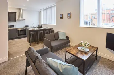 a living room with a couch and a table at Host & Stay - Showtime Studio in Blackpool