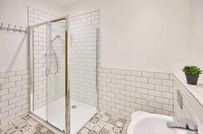 a white bathroom with a shower and a toilet at Host & Stay - Showtime Studio in Blackpool