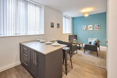 a kitchen with a island with wine glasses on it at Host & Stay - Showtime Studio in Blackpool