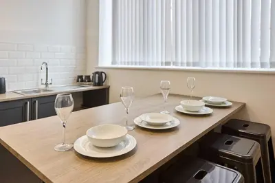 a kitchen with a table with wine glasses on it at Host & Stay - Showtime Studio in Blackpool