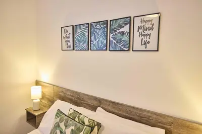 a bedroom with four pictures on the wall above a bed at Host & Stay - Illumination Suite in Blackpool
