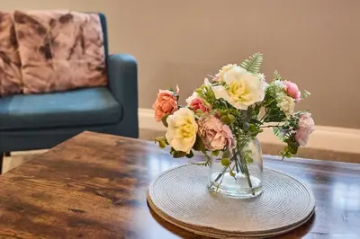 a vase of flowers sitting on a table at Host & Stay - Illumination Suite in Blackpool